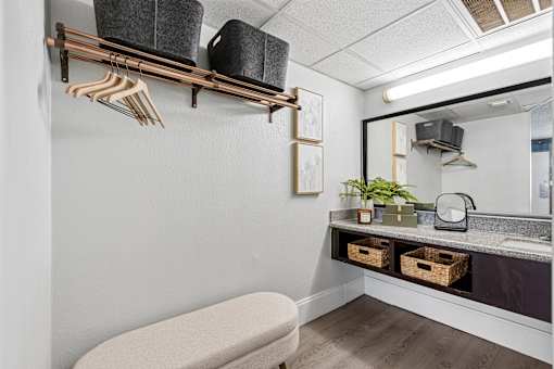 A room with a white wall and a grey floor.