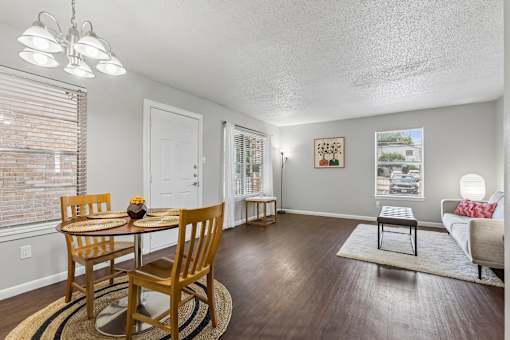 A dining room with a wooden table and chairs.
