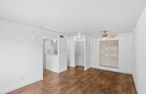 A room with wooden floors and white walls.