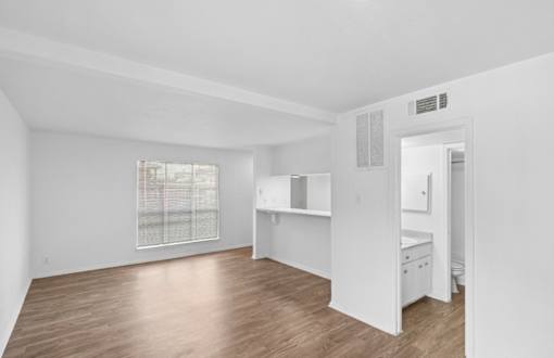 A white room with a window and a desk.