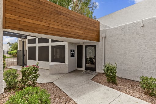 a white building with a wooden awning over the front door