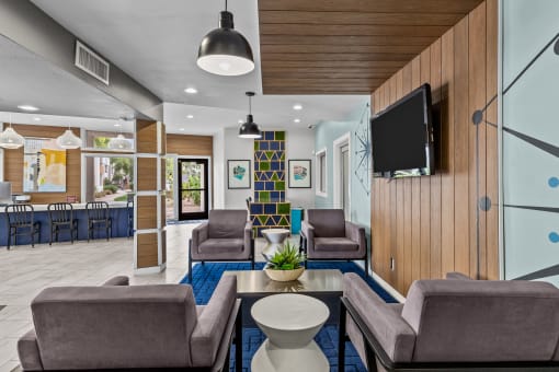 a living room filled with furniture and a flat screen tv
