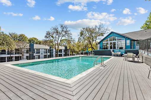 a swimming pool with a house in the background