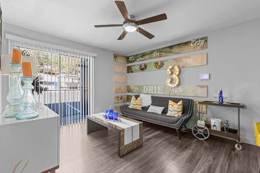 a living room with a couch and a ceiling fan