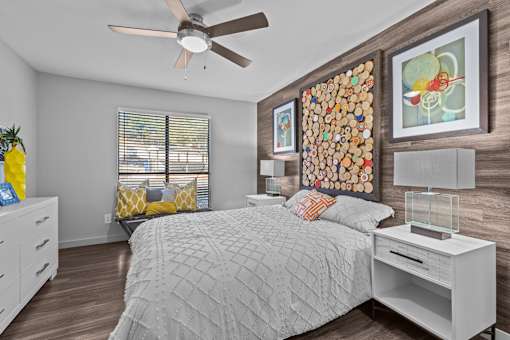 a bedroom with a bed and a ceiling fan