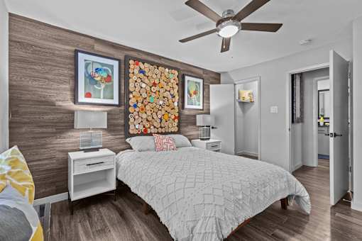 a bedroom with a bed and a ceiling fan