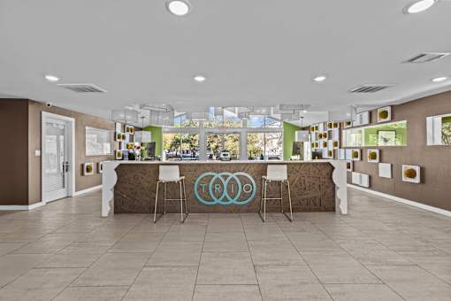 the lobby of the olympic club with a bar and chairs