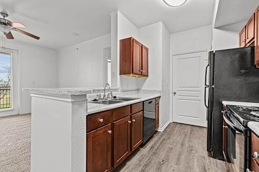 A kitchen with white countertops and brown cabinets.