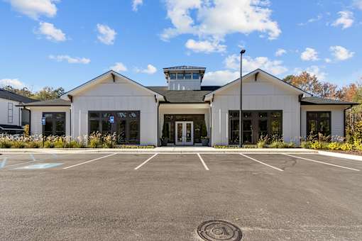 A building with a parking lot in front of it.