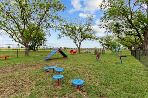 A playground with a slide, swings, and a ball pit.