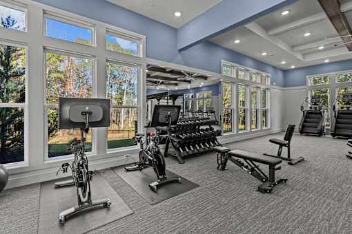 A spacious home gym with a variety of exercise equipment.