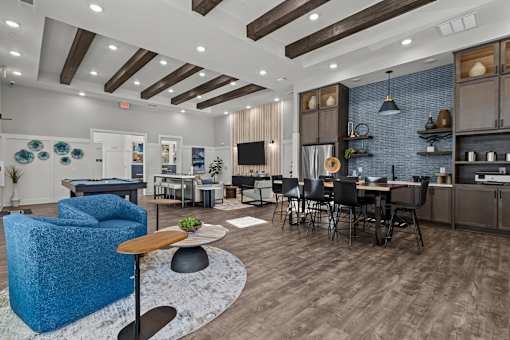 A modern open plan living and kitchen area with a blue sofa.