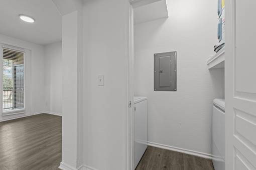 A white room with a door and a window.