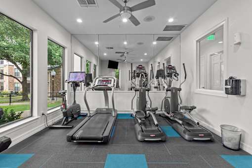 A gym with treadmills and exercise bikes.