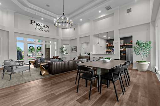 A modern living room with a dining area and a kitchen in the background.