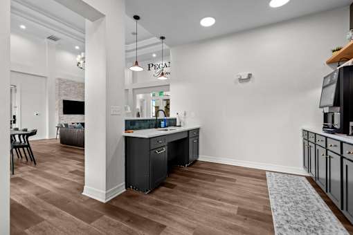 A kitchen area with a counter and cabinets.