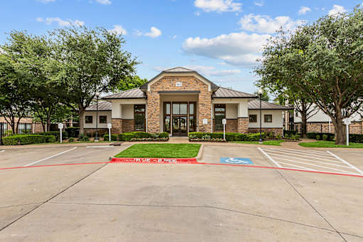 A building with a parking lot in front of it.