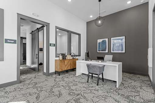 A room with a desk and a chair in it.