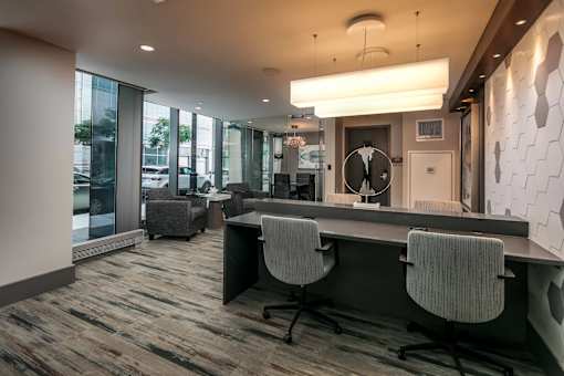 A modern office with a long table and chairs.