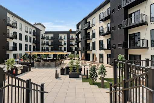 A courtyard surrounded by black and white buildings with balconies.