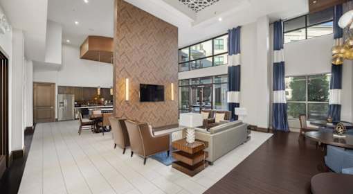 A modern living room with a large sofa set and a wooden coffee table.