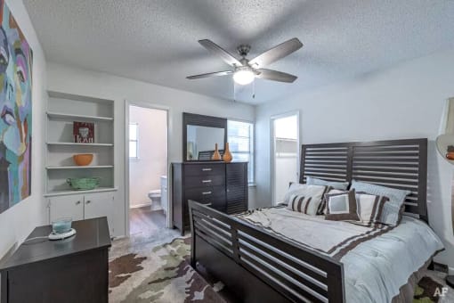 a bedroom with a bed and a ceiling fan