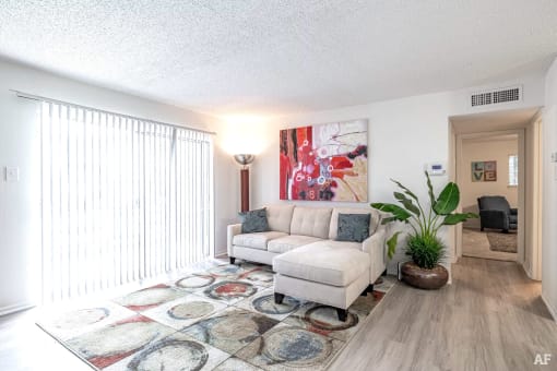 a living room with a couch and a rug