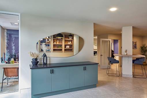 A kitchen with a blue cabinet and a counter with a plant on it.