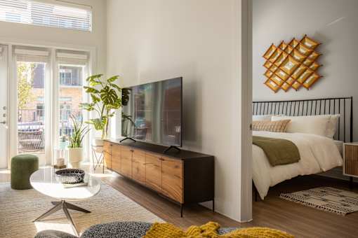 A modern bedroom with a large bed and a flat screen TV.