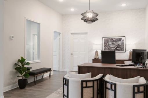 a home office with a desk and three chairs