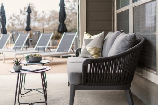 a patio chair with pillows on it