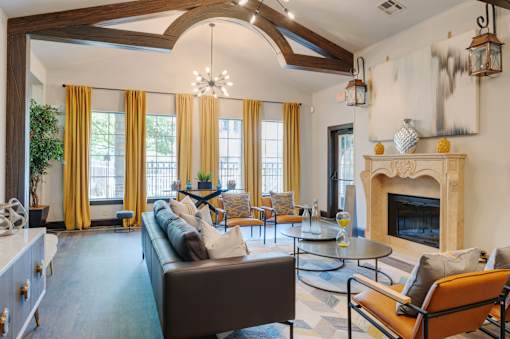 A living room with a brown couch and a fireplace.