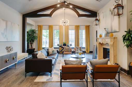 A living room with a fireplace and a large window.