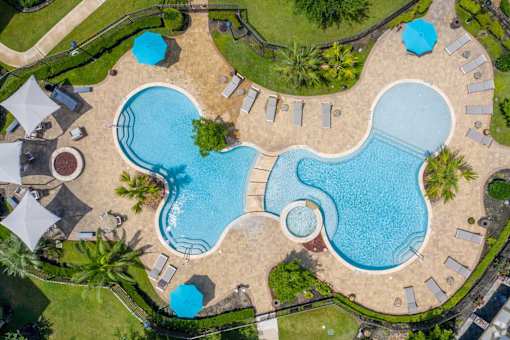 A large outdoor swimming pool surrounded by a grassy area.