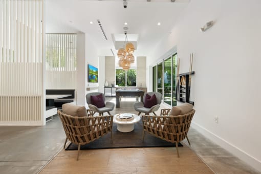 a living room with two chairs and a table and a fireplace