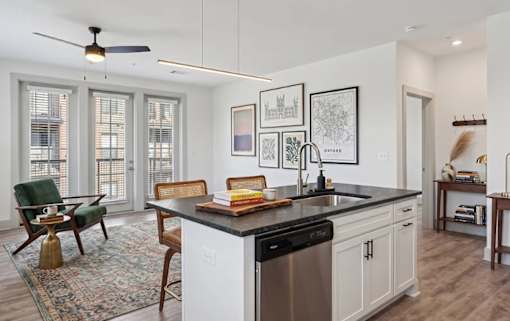 A modern kitchen with a large island and a dining table.