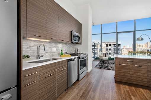 A modern kitchen with wooden cabinets and stainless steel appliances.
