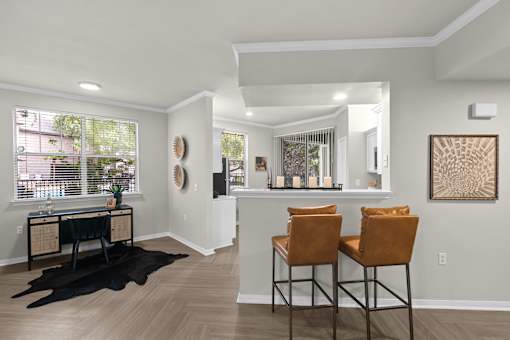 A room with a bar and two chairs.