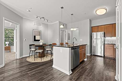 A modern kitchen with a dining table and chairs.