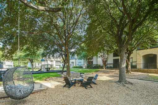 A park with benches and trees.