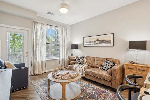 A living room with a brown couch and a coffee table.