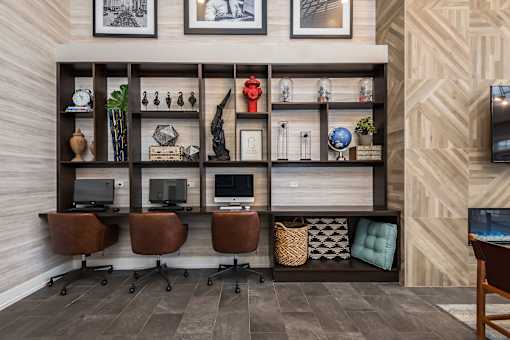 A room with a wooden shelf, chairs, and a desk.