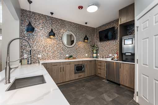 A kitchen with a sink and a counter top.