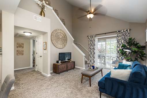 A living room with a blue couch and a television.