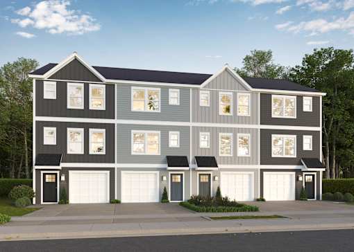 A modern two-story house with a grey and white exterior and black garage doors.