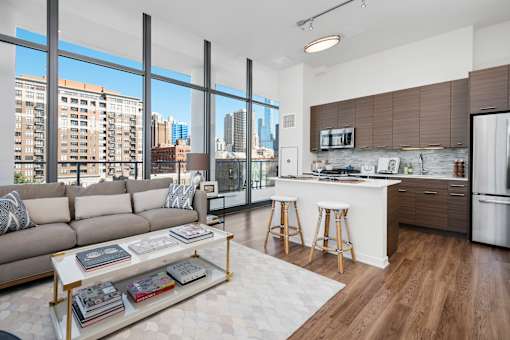 A modern living room with a large window overlooking the city.