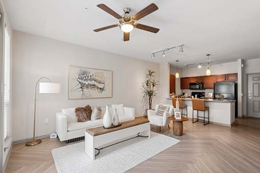 A living room with a white couch and a ceiling fan.
