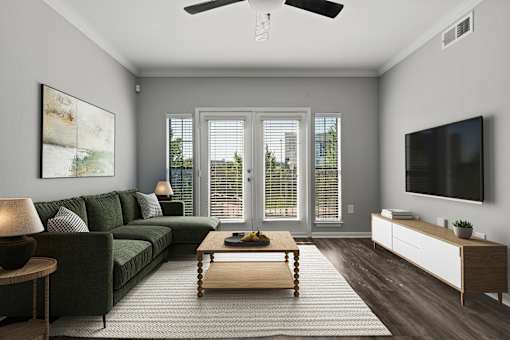 A modern living room with a dark green sofa and a wooden coffee table.