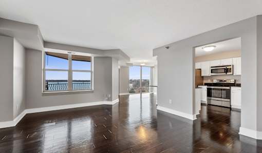 A spacious living room with a view of the balcony.