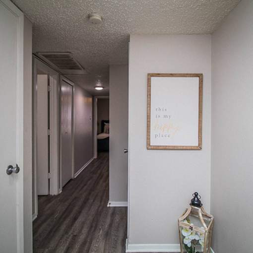 A hallway with a framed sign that says "this is my place".